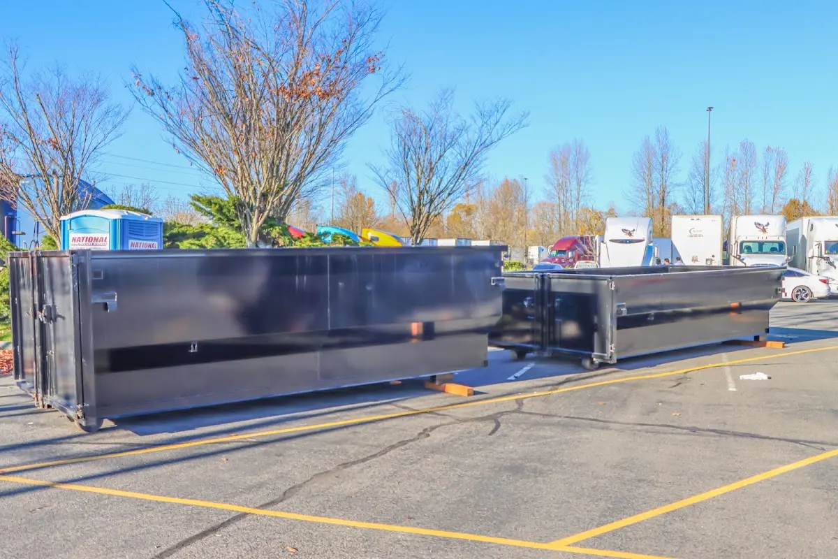 Professional dumpster rental service with roll-off container on residential driveway in Bellair-Meadowbrook Terrace